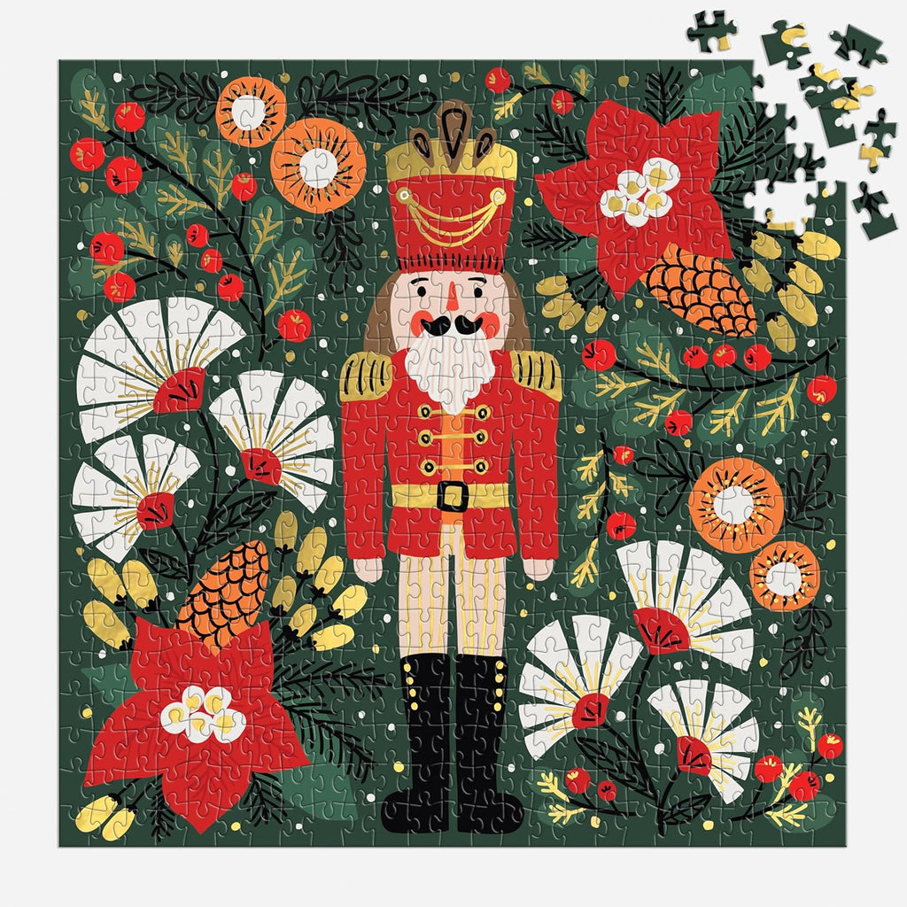 Galison Merry Nutcracker 500-piece Christmas jigsaw puzzle partially completed with remaining pieces showing puzzle-solving process